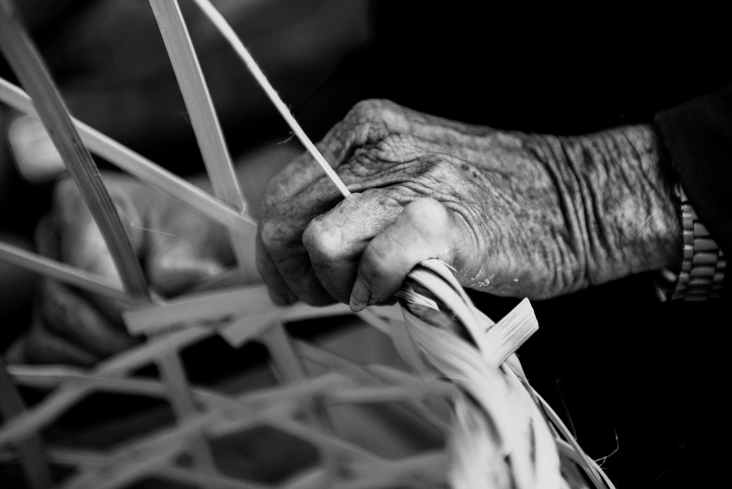 Cropped Image Of Senior Man Weaving Basket