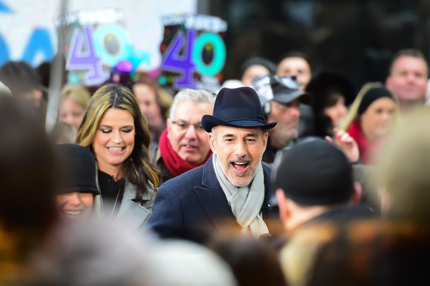 Matt Lauer smiling in a large crowd in New York City