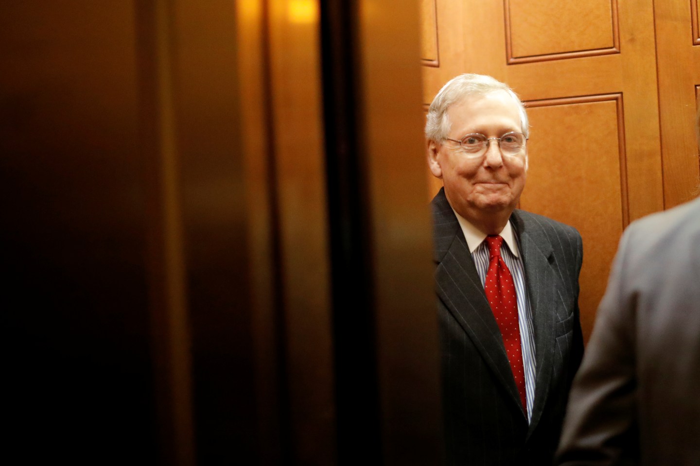 Senate Majority Leader Mitch McConnell (R-KY) smiles as he leaves the Republicans weekly policy luncheon on Capitol Hill in Washington