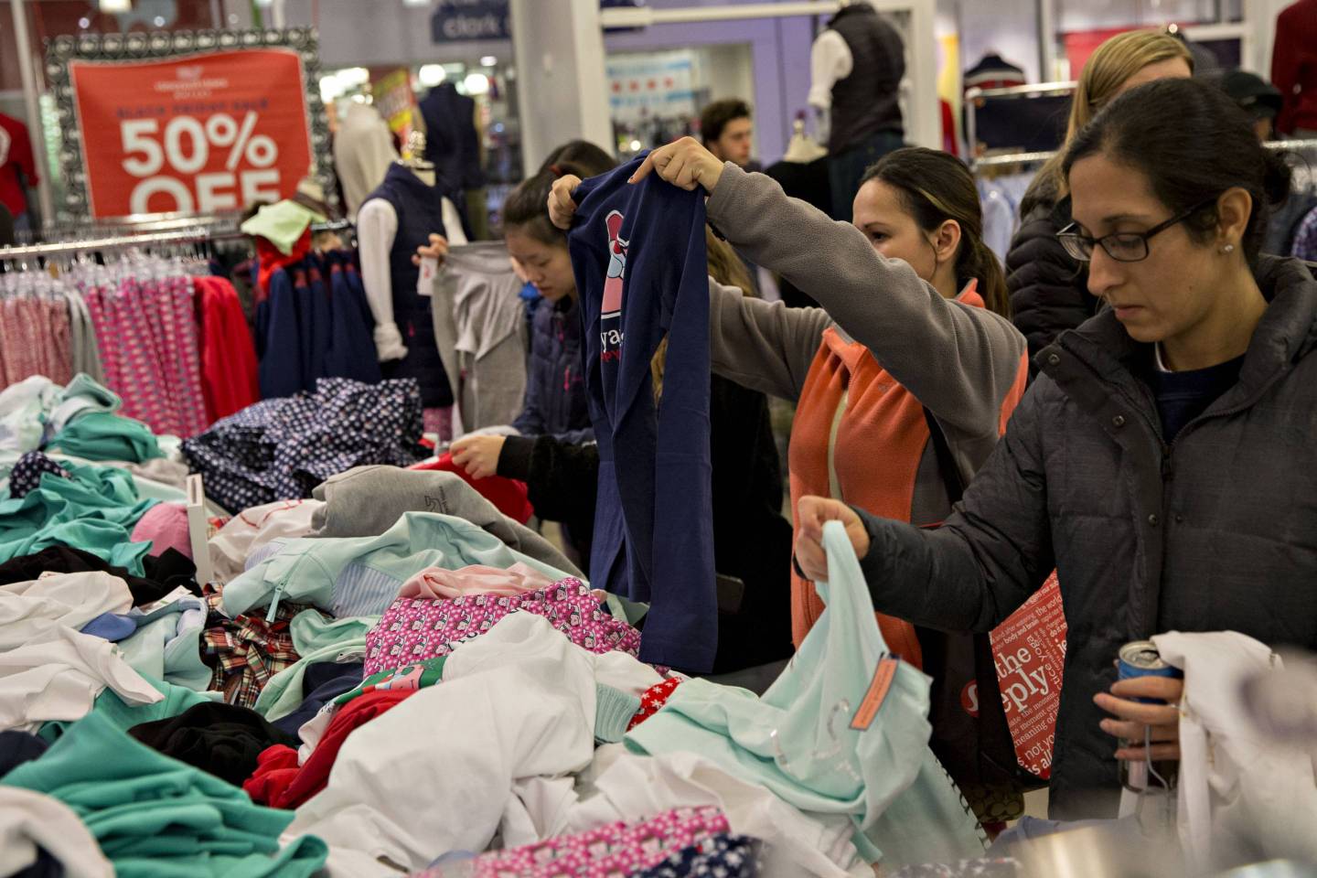 Shoppers look at clothes in a Vineyard Vines store in Chicago, Illinois, U.S., on Thursday, Nov. 23, 2017.