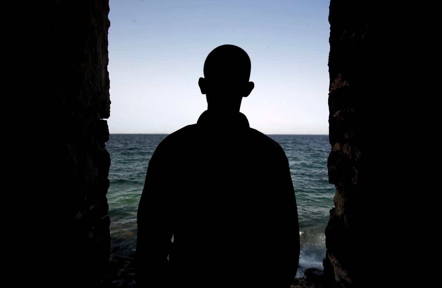 A man is silhouetted in the "Door of No Return" at the House of Slaves on Goree Island near Senegal's capital Dakar