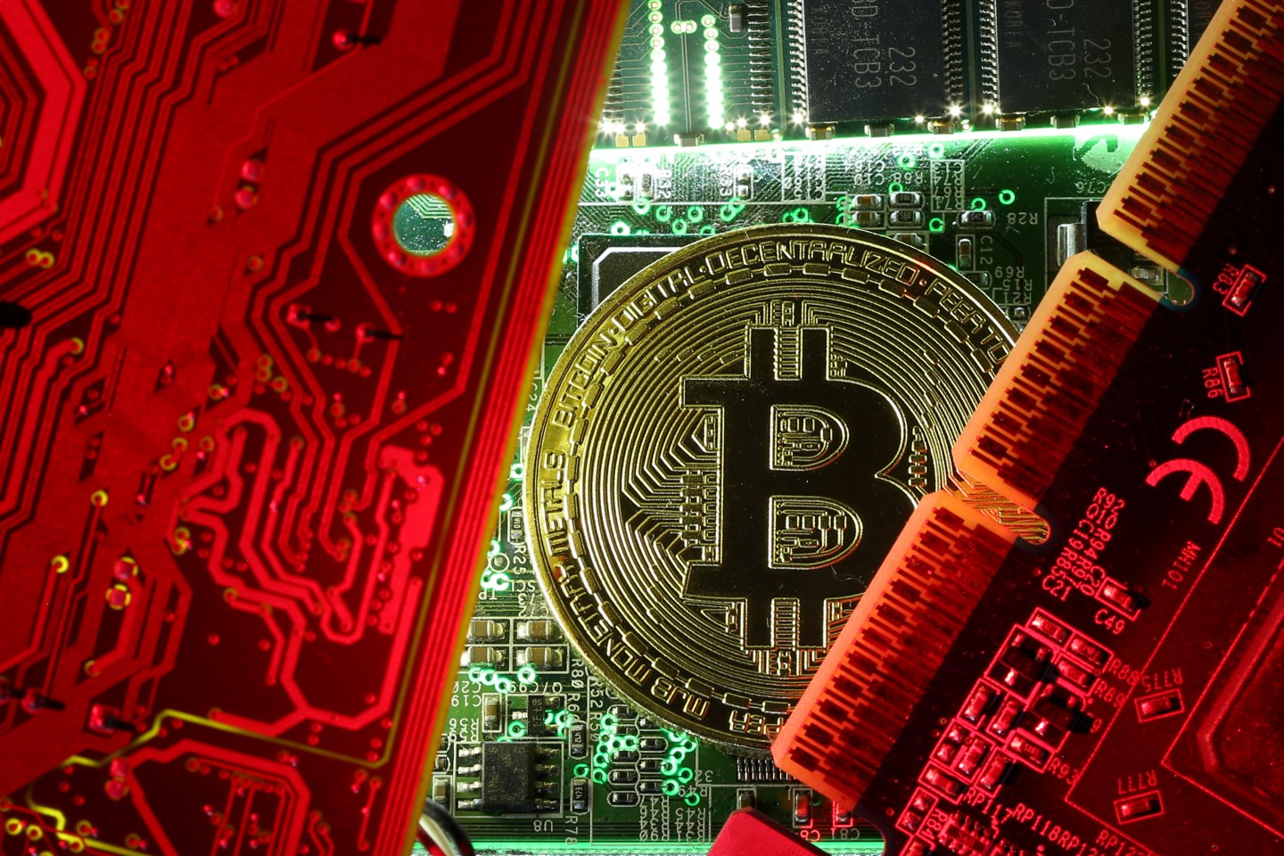 FILE PHOTO: A coin representing the bitcoin cryptocurrency is seen on computer circuit boards in this illustration picture