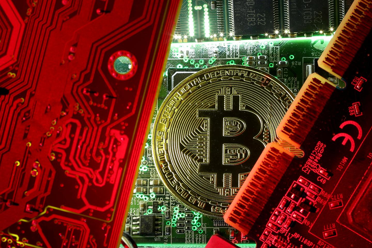 FILE PHOTO: A copy of bitcoin standing on PC motherboard is seen in this illustration picture