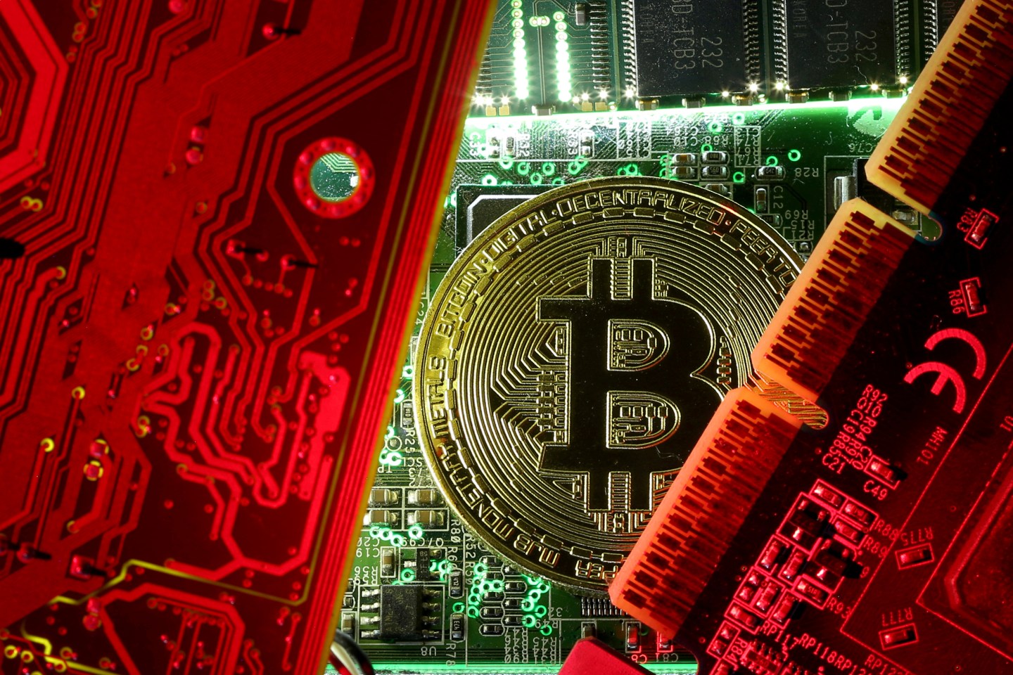 FILE PHOTO: A copy of bitcoin standing on PC motherboard is seen in this illustration picture