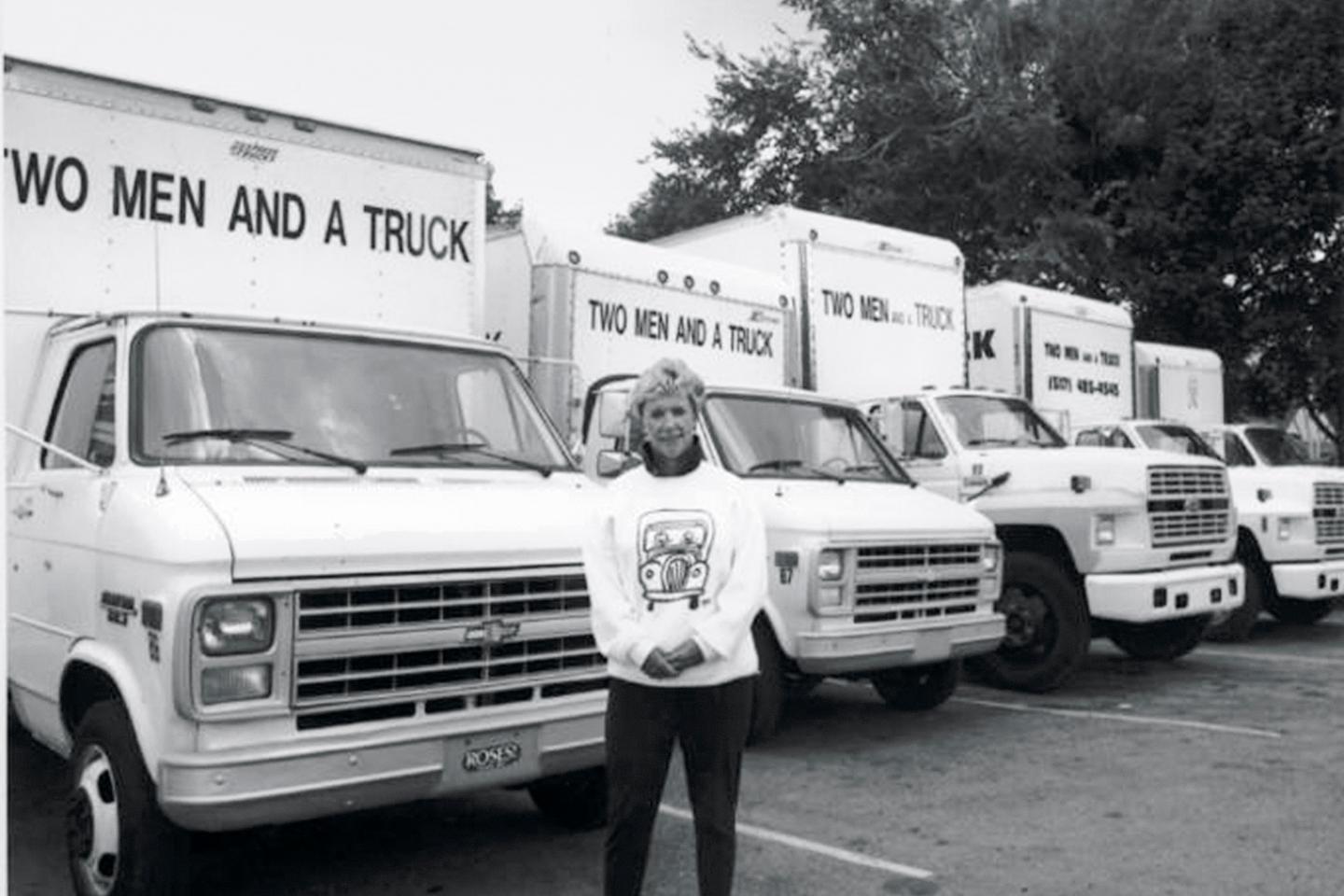 Mary Ellen Sheets stands proudly in front of the Two Men and a Truck fleet in Lansing in 1991.