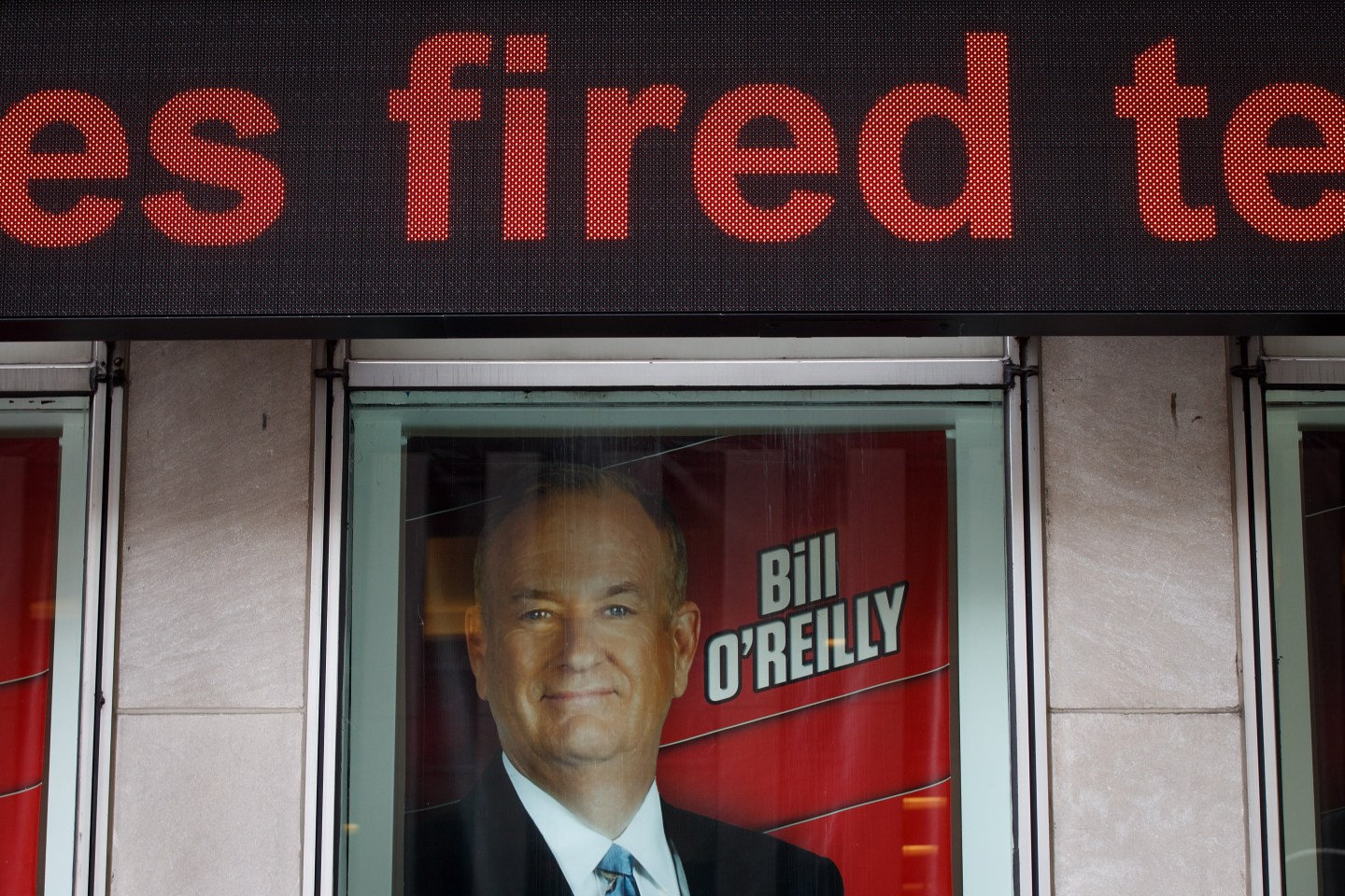 Advertisements for Fox News and Bill O'Reilly stand in a window outside of the News Corp. and Fox News headquarters in Midtown Manhattan, April 19, 2017 in New York City.