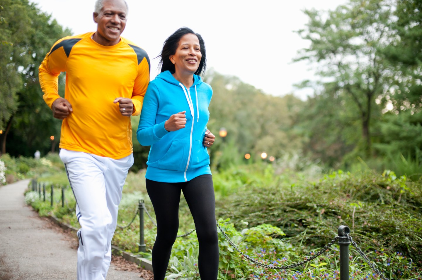 Older couple jogging in park
