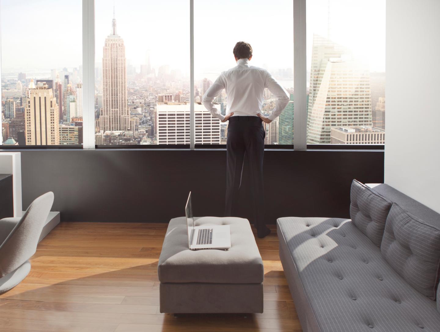 Young man looking out at city skyline