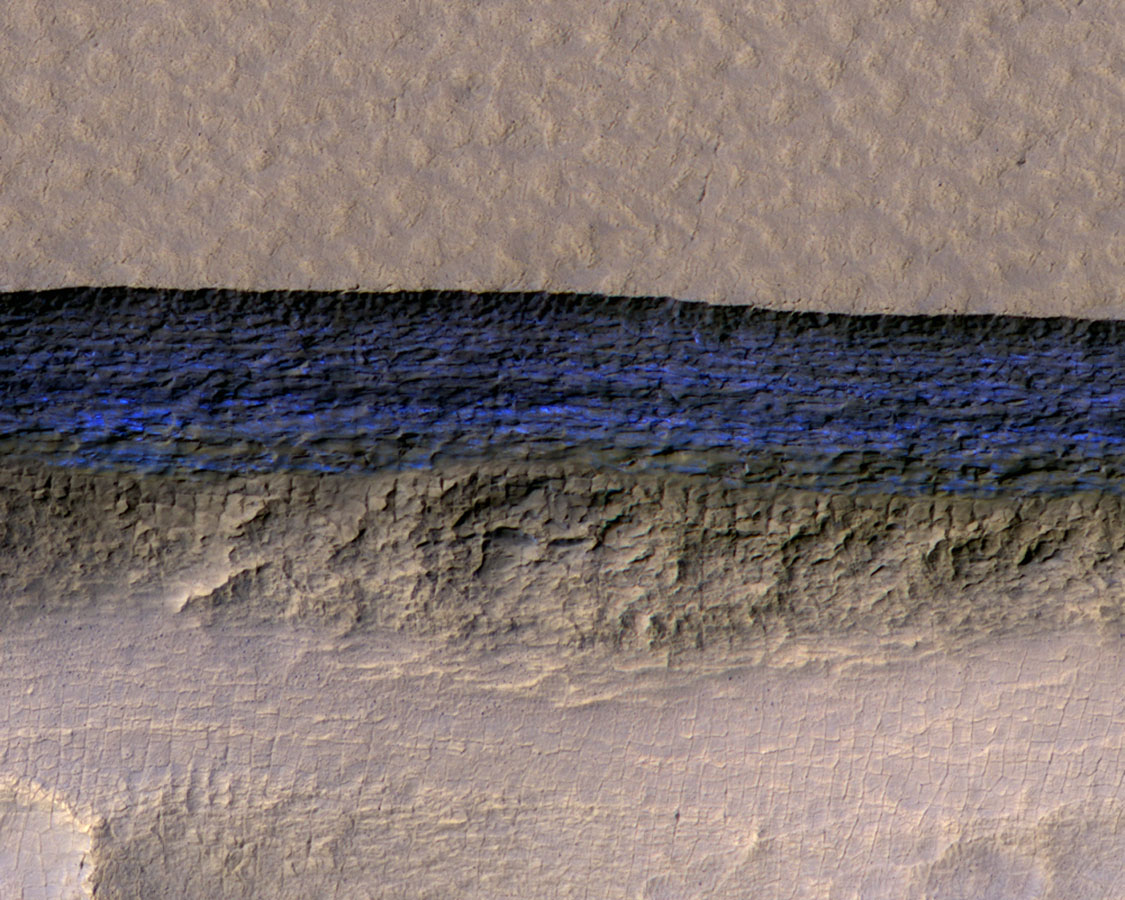 "A cross-section of underground ice is exposed at the steep slope that appears bright blue in this enhanced-color view from the HiRISE camera on NASA's Mars Reconnaissance Orbiter," from NASA.