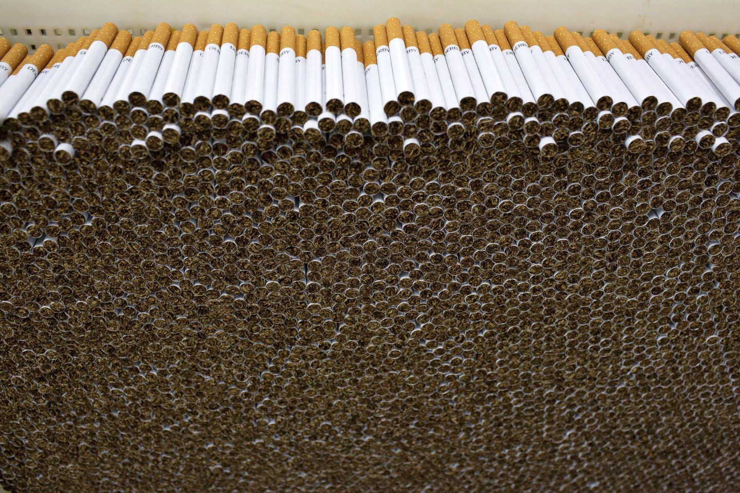 Stacks of cigarettes stand at the Philip Morris International (PMI) Coltabaco SAS production facility in Medellin, Colombia, on Friday, June 2, 2017.