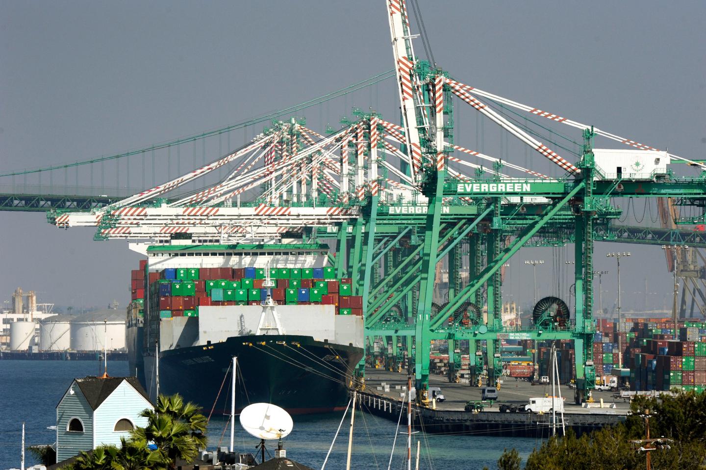 Freighters and cargo containers sit idle at the Port of Los Angeles as a back-log of over 30 container ships sit anchored outside the Port in Los Angeles