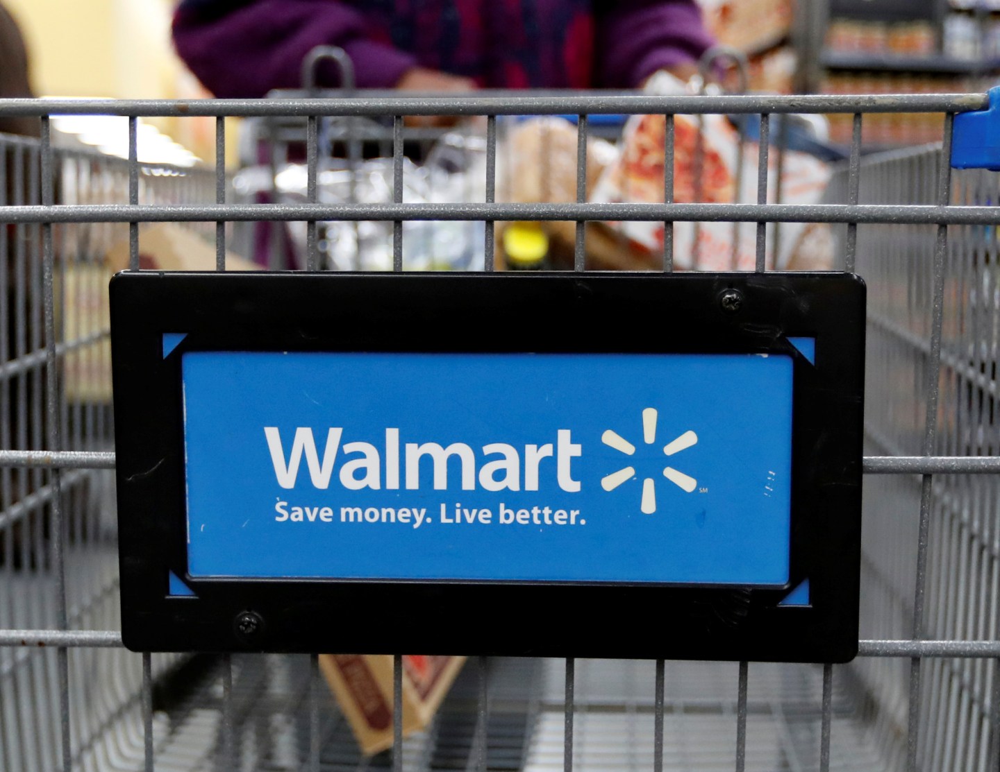 A customer pushes a shopping cart at a Walmart store in Chicago