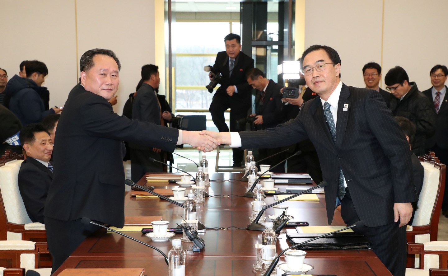 Head of the North Korean delegation, Ri Son Gwon shakes hands with his South Korean counterpart Cho Myoung-gyon during their meeting at the truce village of Panmunjom