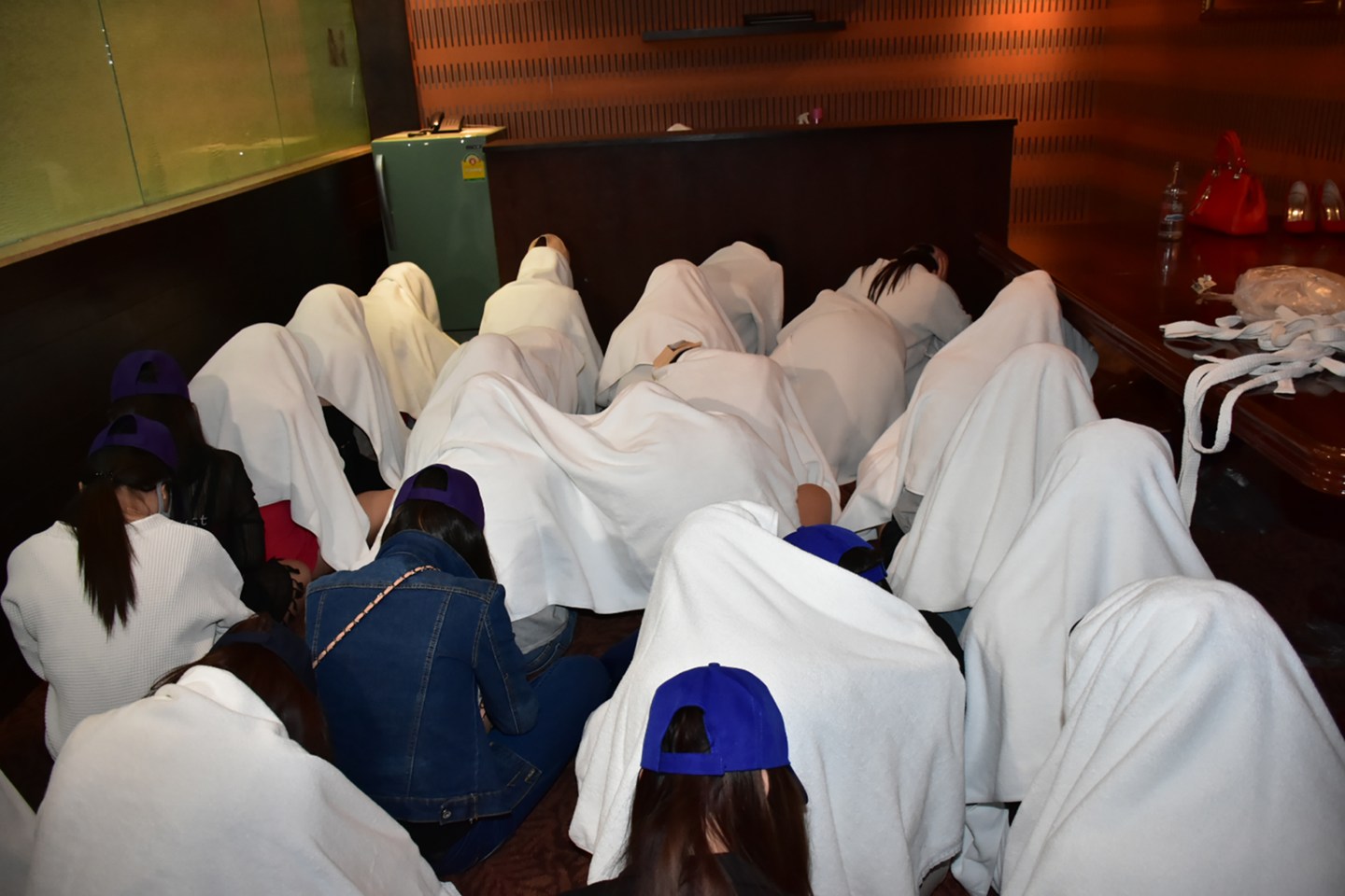 Female workers detained at a massage parlor in Thailand after police raided the premises on suspicions of underage trafficking and prostitution.