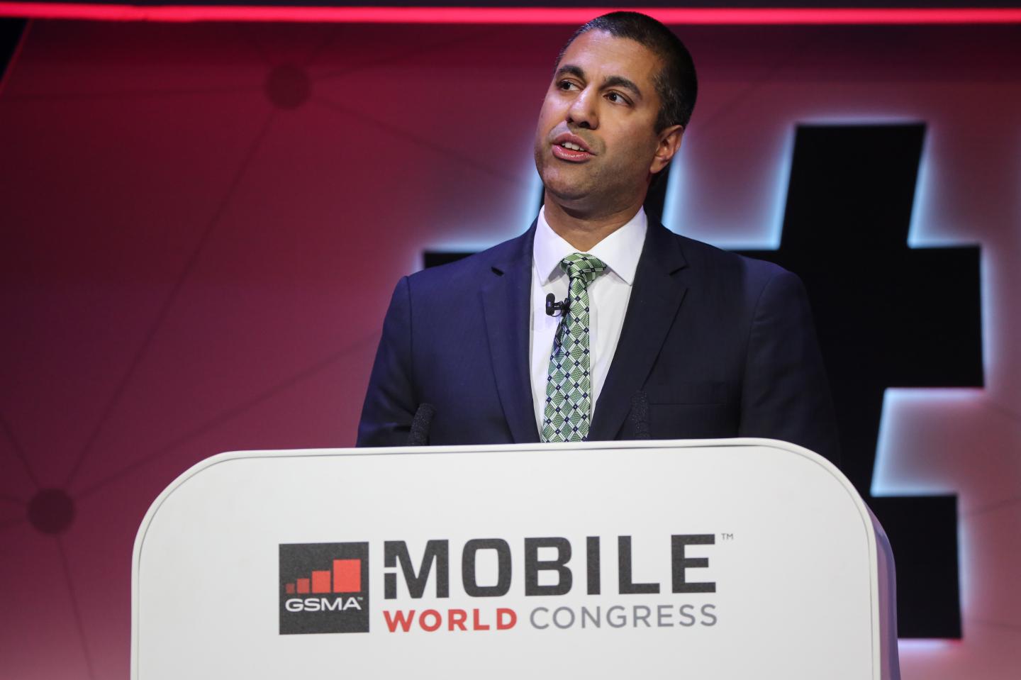 FCC Chair Ajit Pai speaks at a podium at the Mobile World Congress