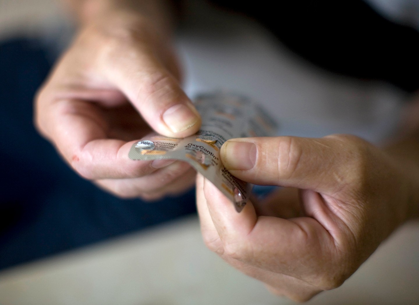 Jack Rosser, a cancer patient holds OxyContin pain releif ta