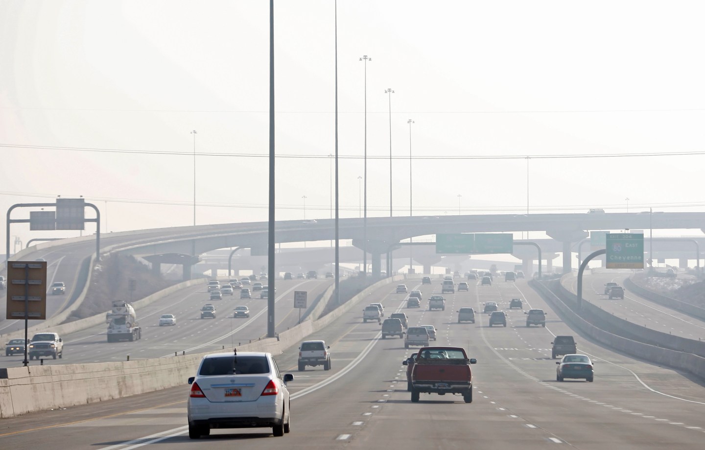 Cars on a highway in heavy smog south of downtown Salt Lake City in Utah, U.S., on Monday, Jan. 11, 2010.
