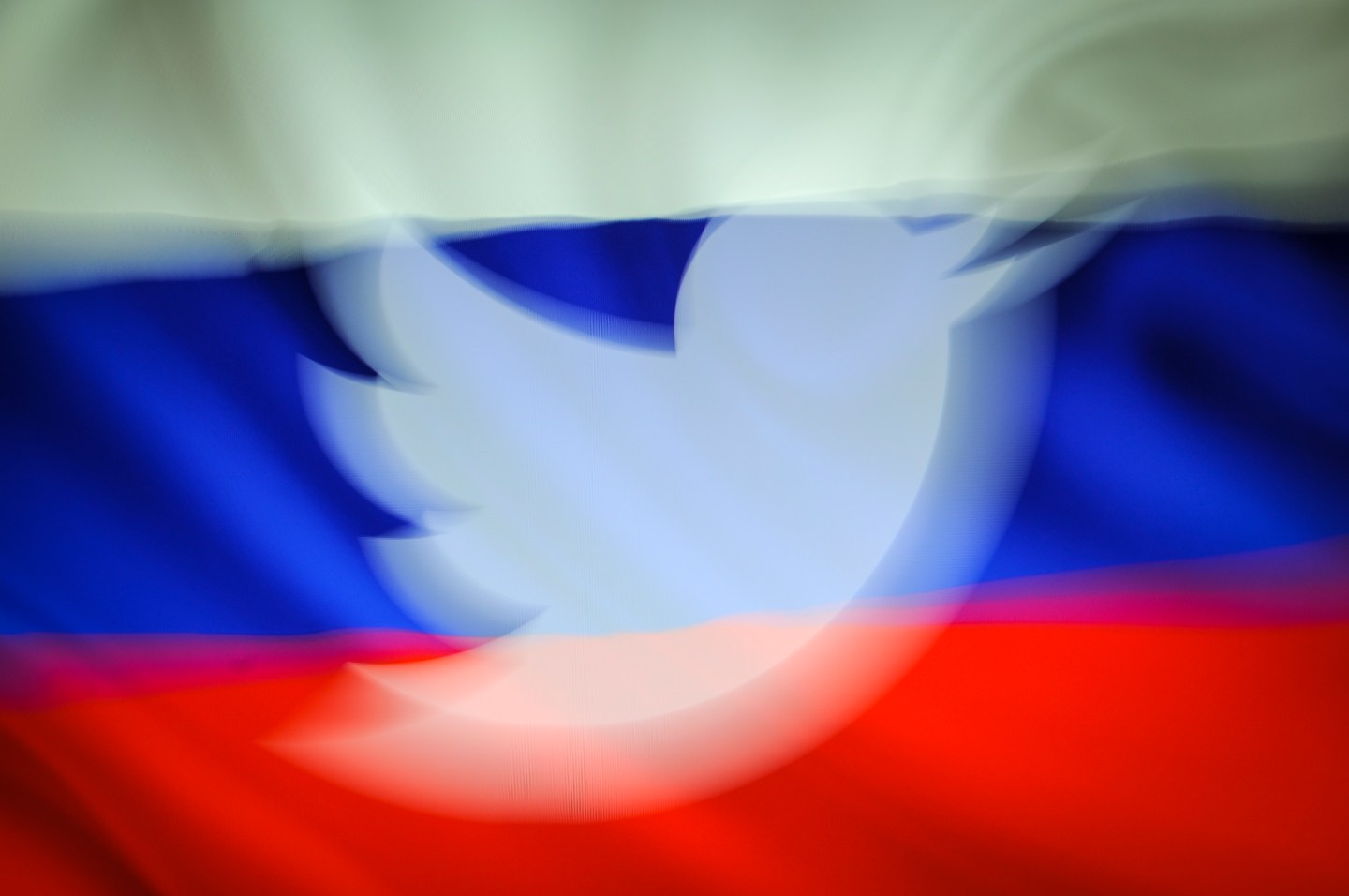 A Twitter logo is imposed over the Russian flag in this photo illustration.
