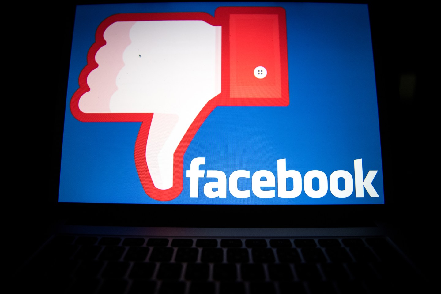 A thumbs-down version of the Facebook logo on a computer monitor in Tokyo, Japan.
