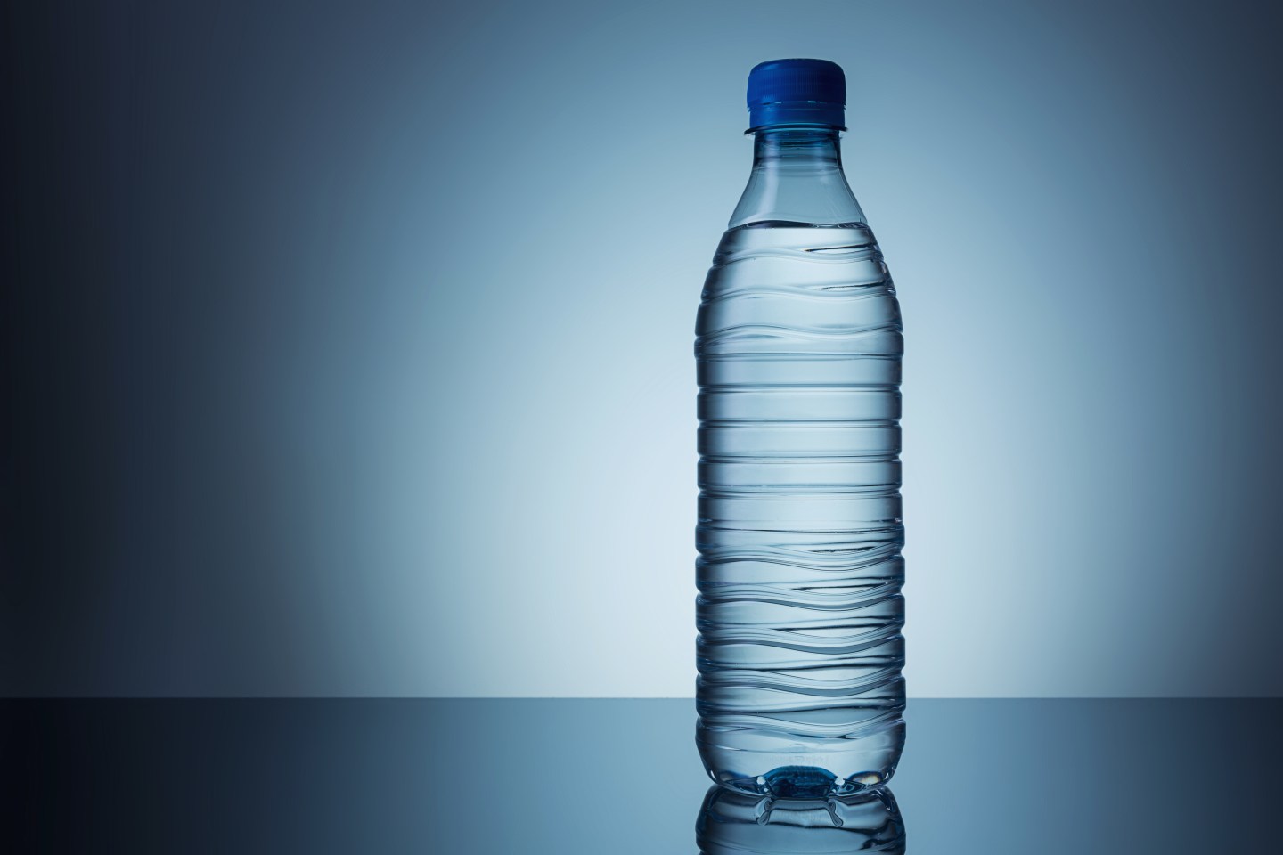 Close-Up Of Water Bottle Against Gray Background