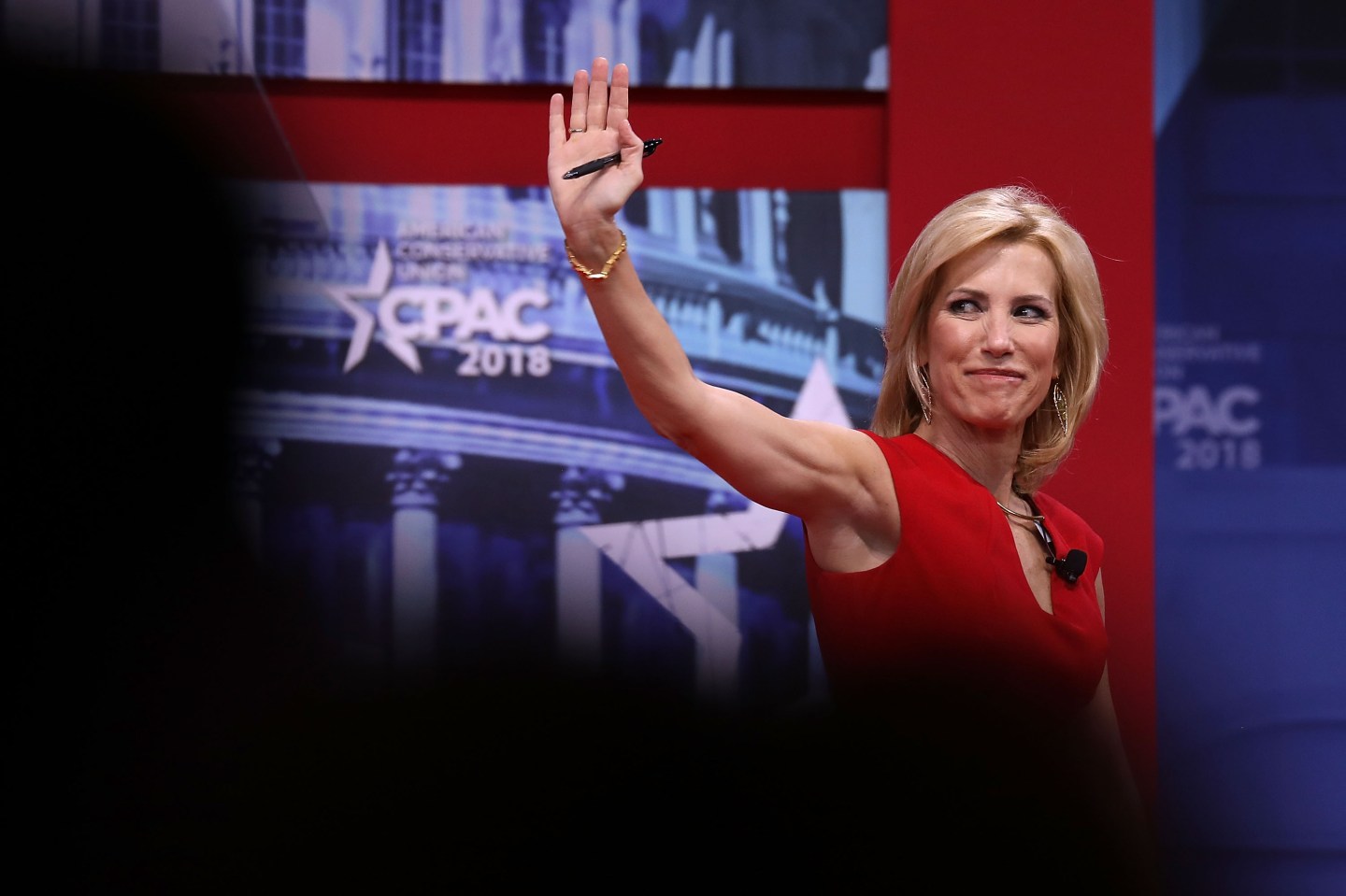 Laura Ingraham, Fox News host, waves to crowd from CPAC stage