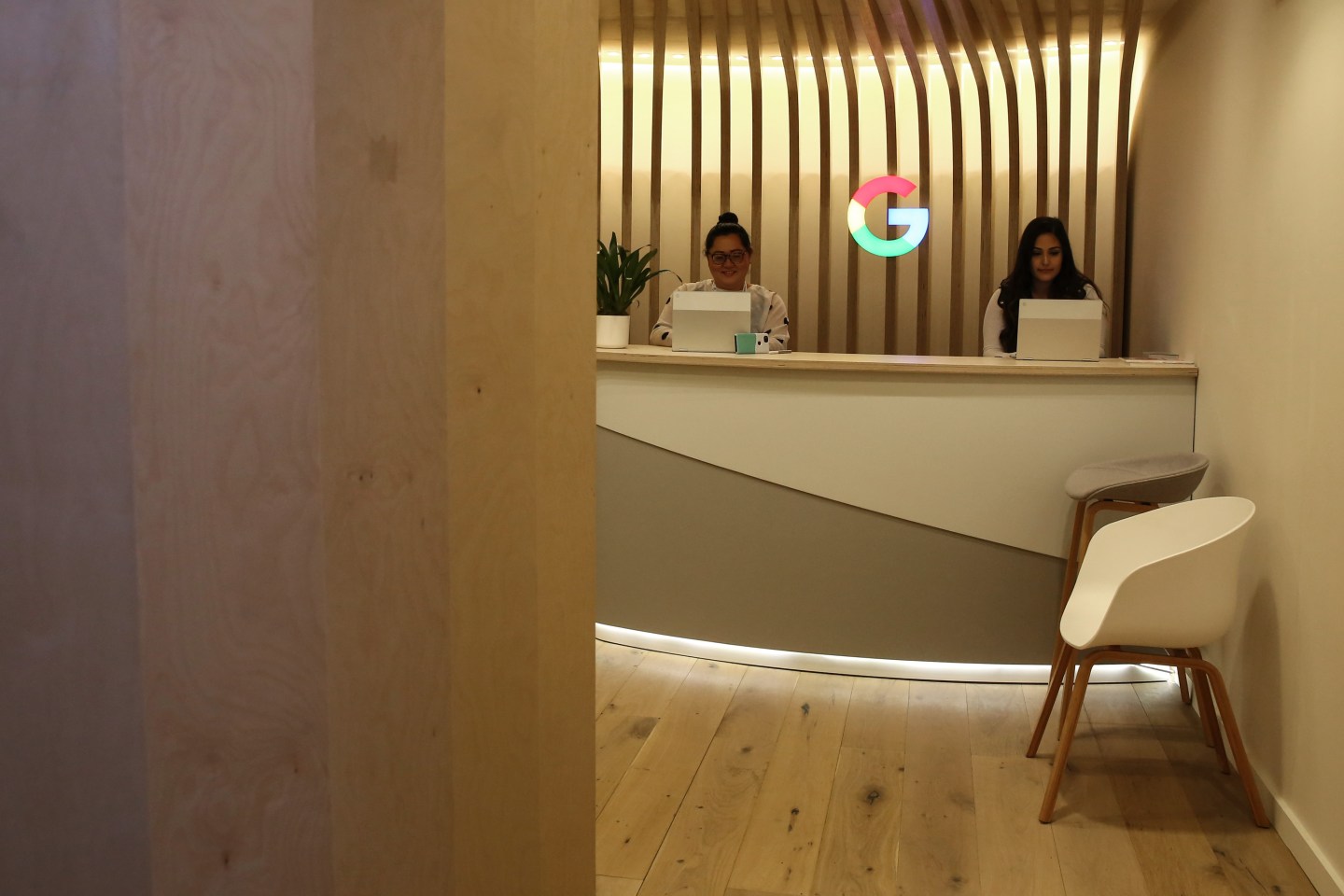 Google logo appears between two women at a desk at Mobile World Congress