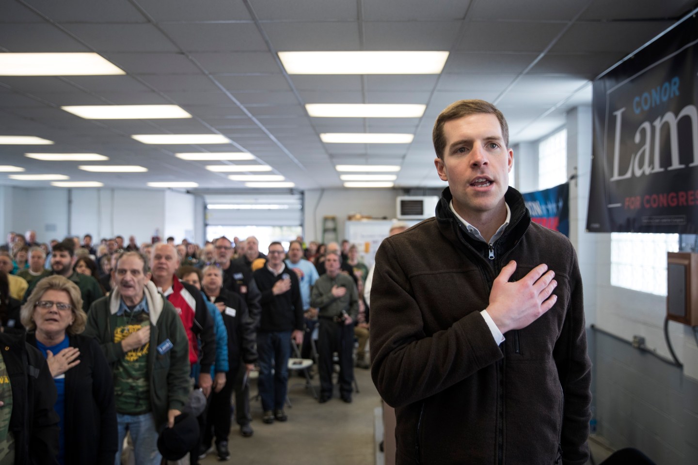 Democratic Conor Lamb crosses his heart during Pledge of Allegiance before Pennsylvania campaign rally
