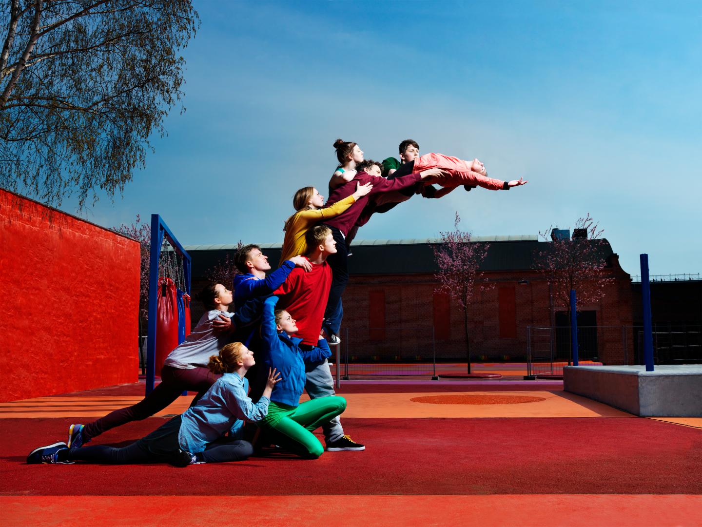 young people creating human statue