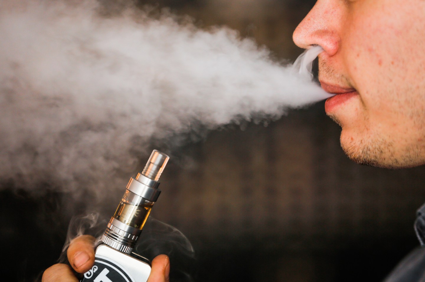 A man smokes an electronic cigarette vaporizer, also known as an e-cigarette, in Toronto