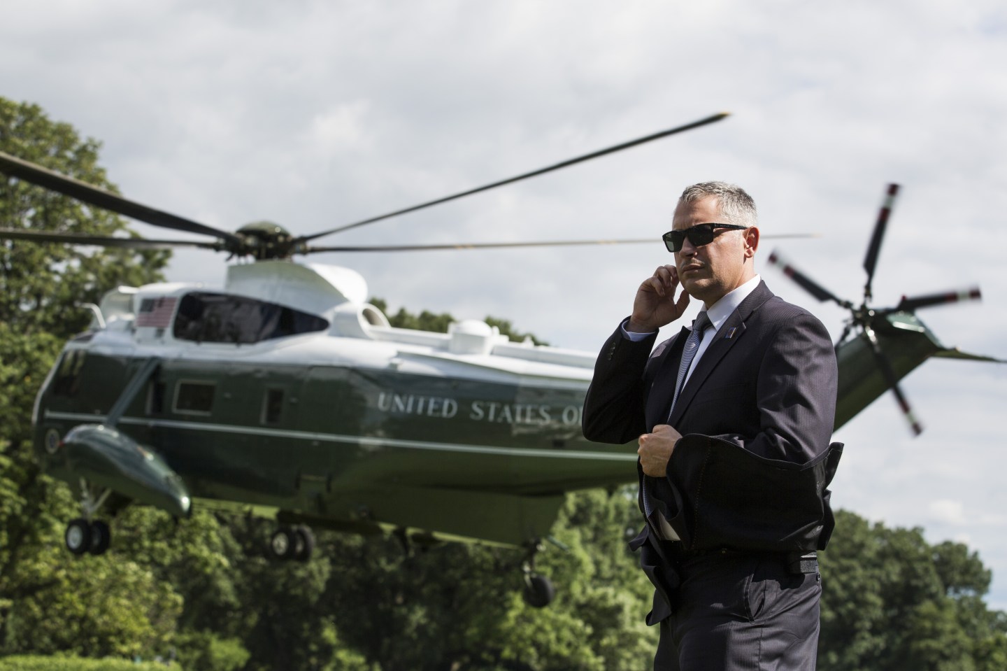 A U.S. Secret Service Agent stands as Marine One departs the White House.