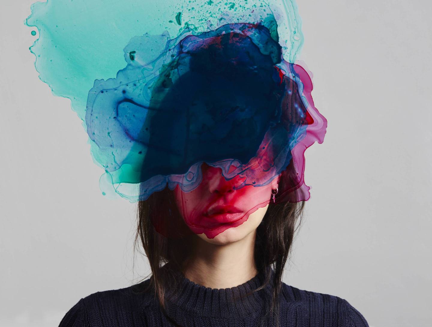 Woman with ink over her face