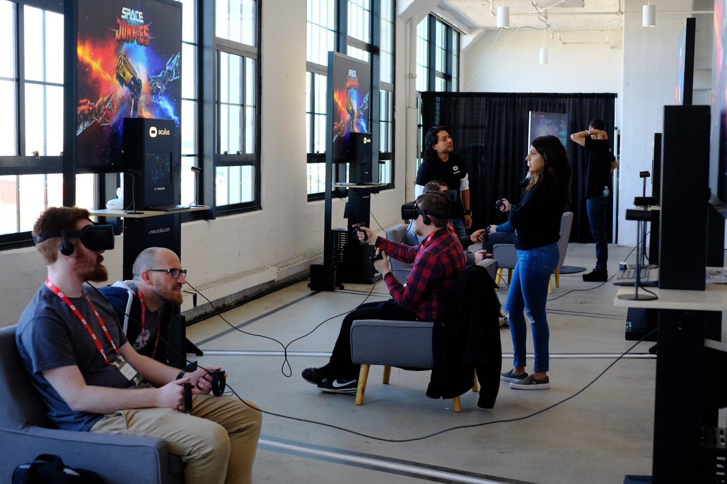 People trying new virtual reality games using Oculus gear