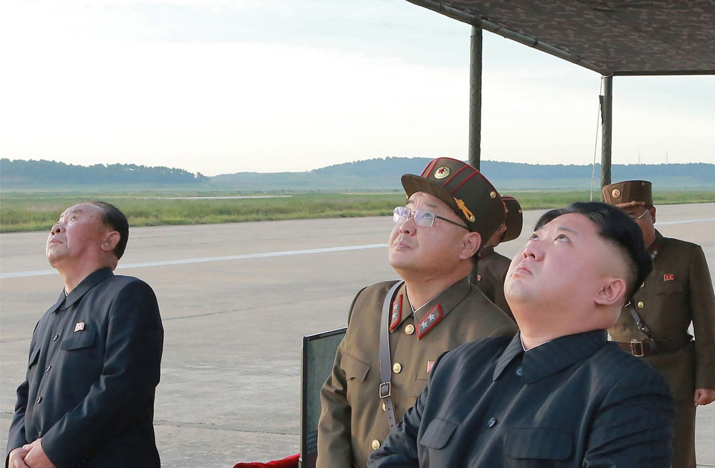 Kim Jong-un of North Korea looks up alongside military personnel in undated photo