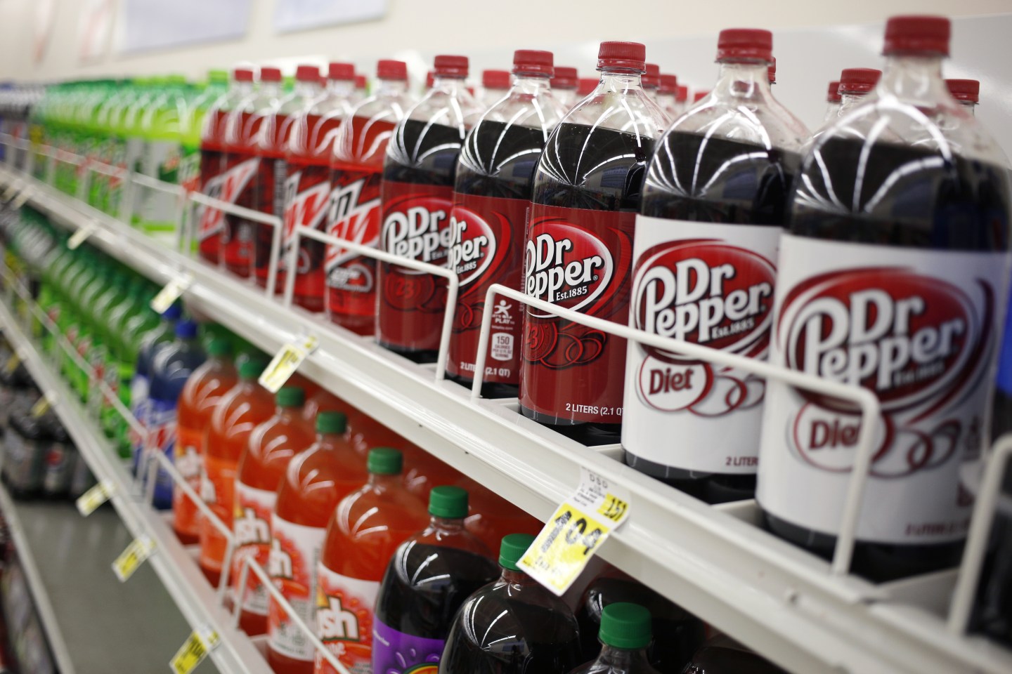Two-liter bottles of Dr. Pepper appear on grocery store shelf
