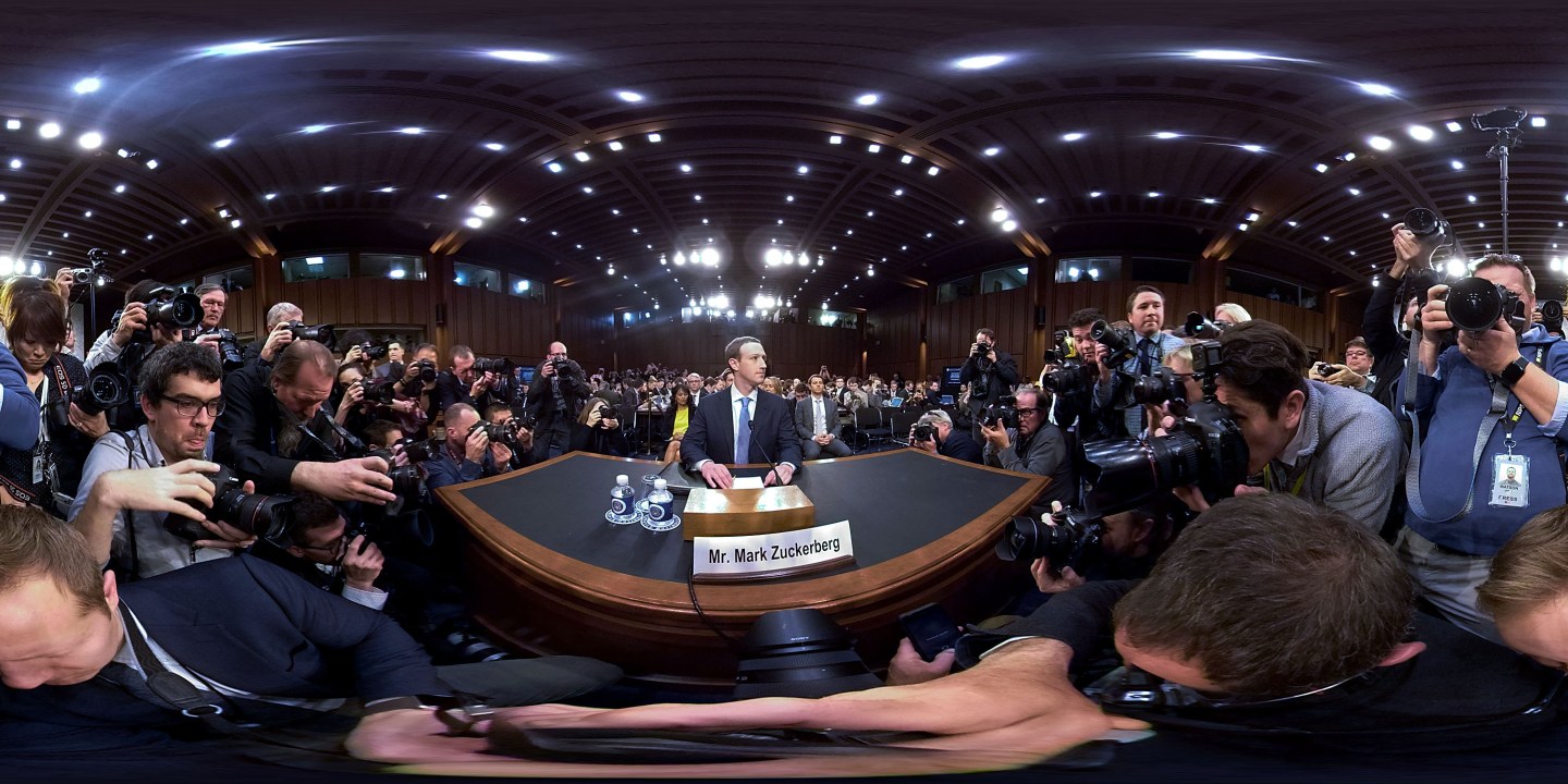 A wide-angle view of Facebook CEO Mark Zuckerberg at a desk before his Senate testimony.