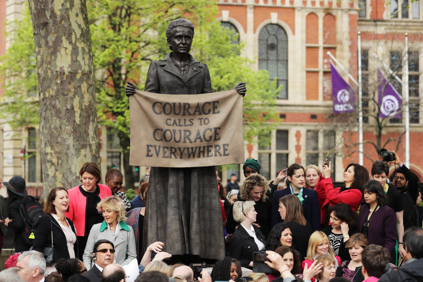 Crowd stands around news statue of Millicent Fawcett in Parliament Square in London