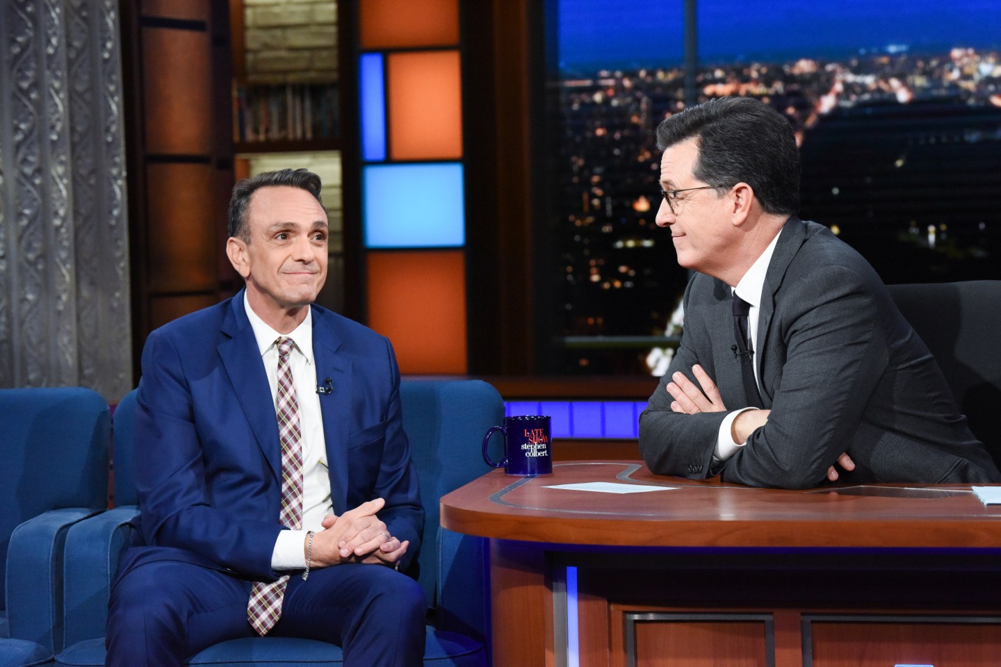 Hank Azaria sits for an interview with host Stephen Colbert