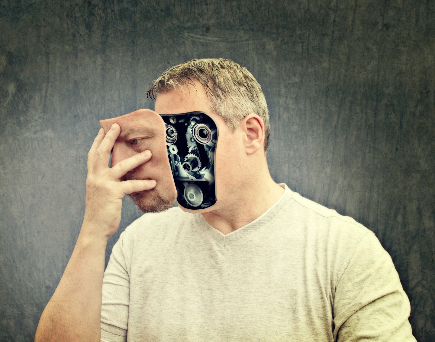 A robot man removing his face.