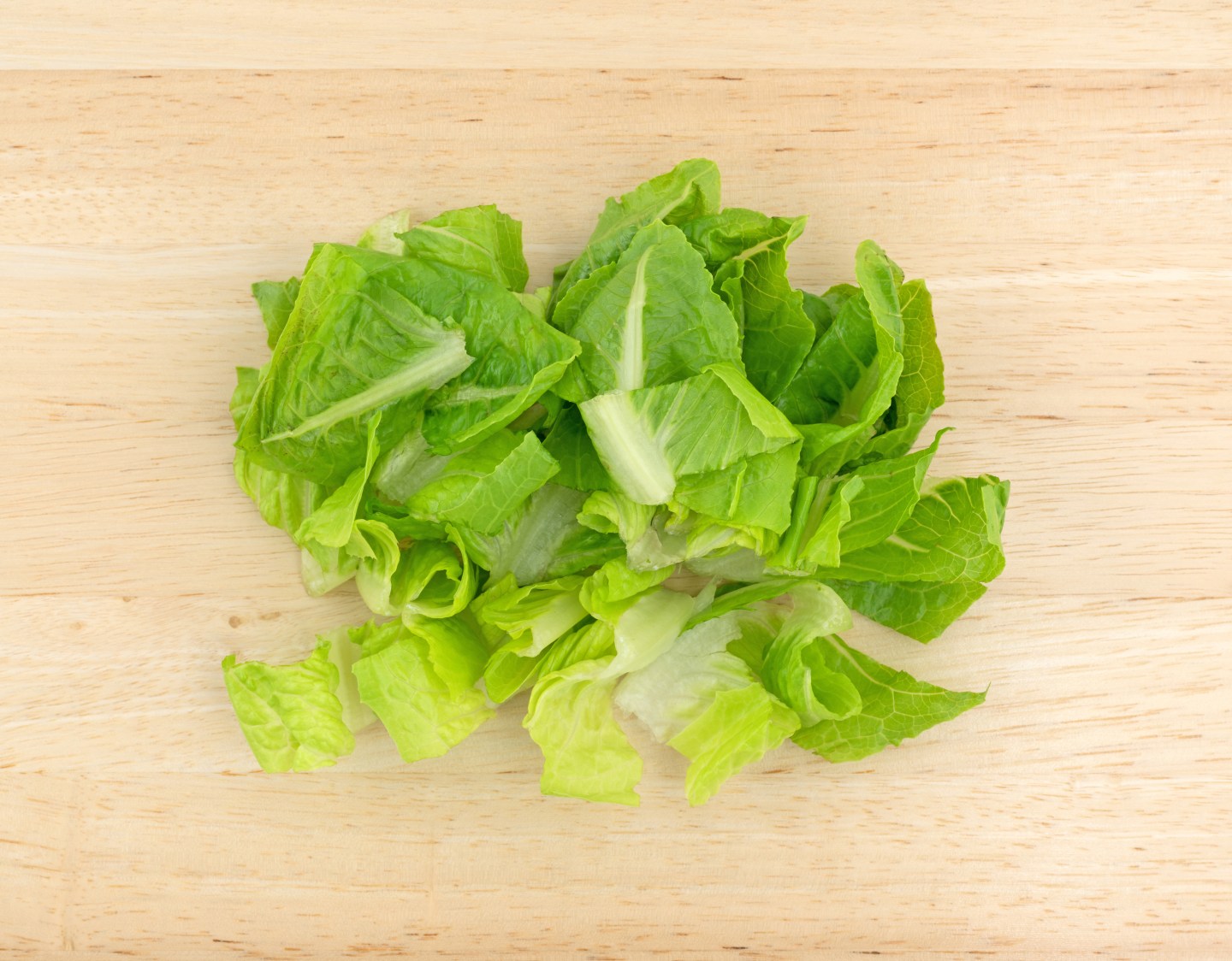 Romaine lettuce on wood cutting board