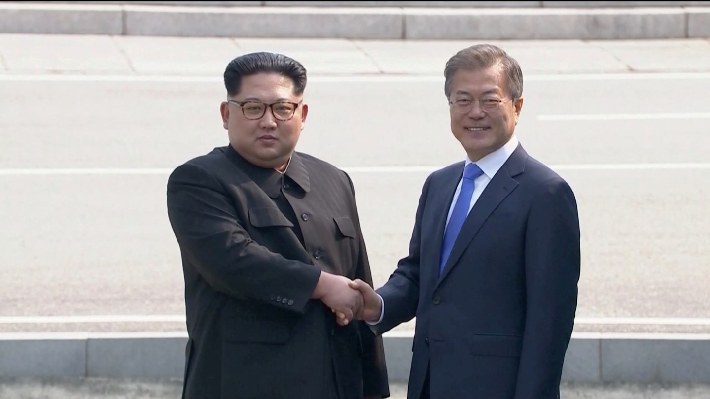 North Korean leader Kim Jong Un shakes hands with South Korean President Moon Jae-in as both of them arrive for the inter-Korean summit at the truce village of Panmunjom, in this still frame taken from video