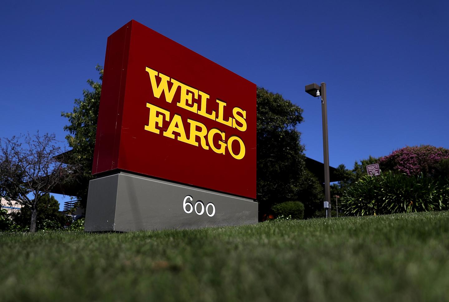A sign sits in front of a Wells Fargo bank office in San Rafael, Calif.