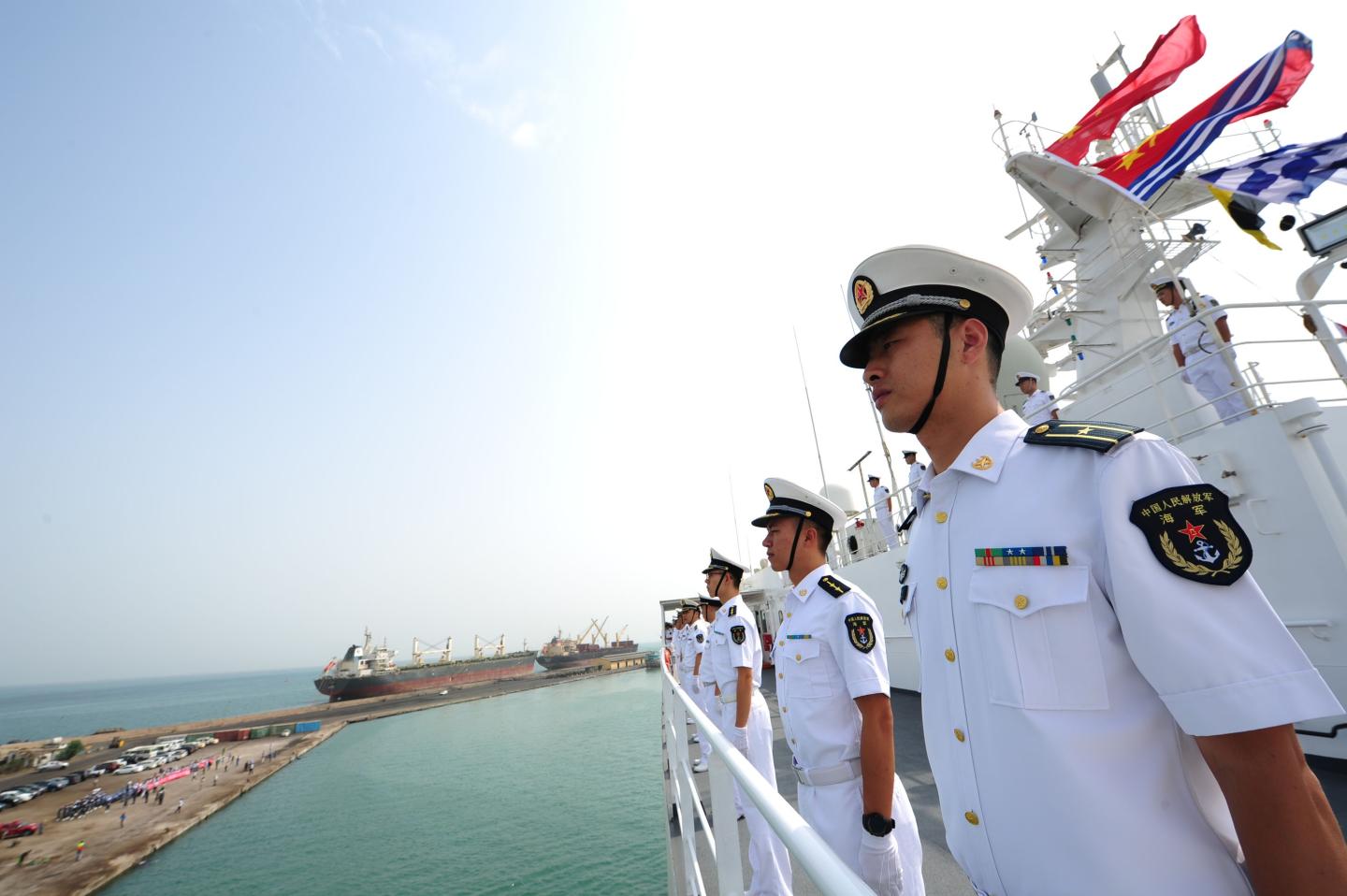 Paramedics stand on the deck of a Chinese hospital ship as it arrives at the port of Djibouti.