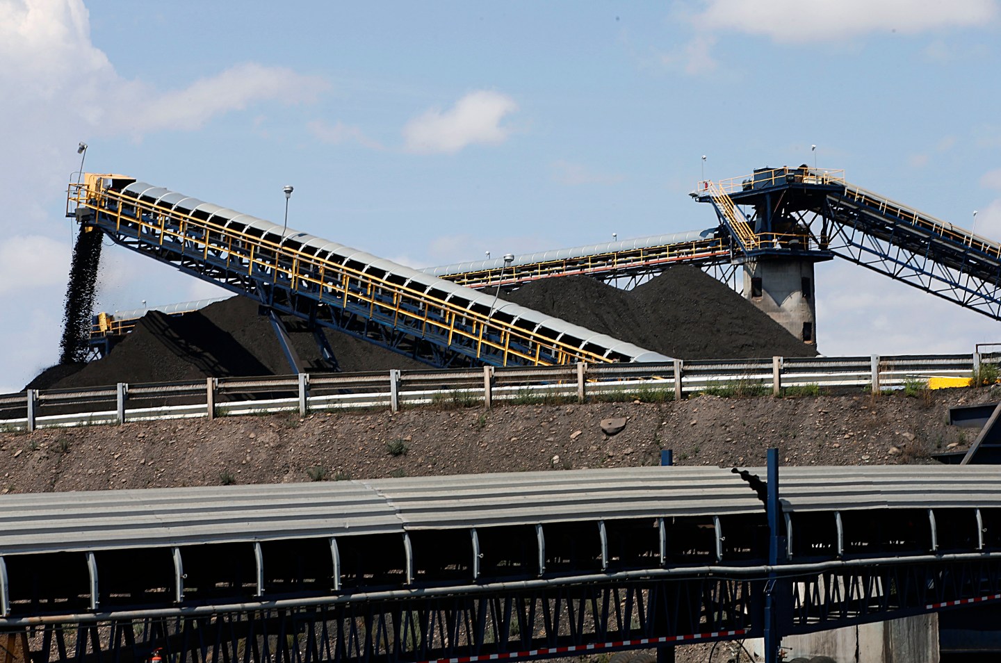 Coal falls off a conveyer belts as it's offloaded from trucks from local coal mines at the Savage Energy Terminal in Price, Utah.
