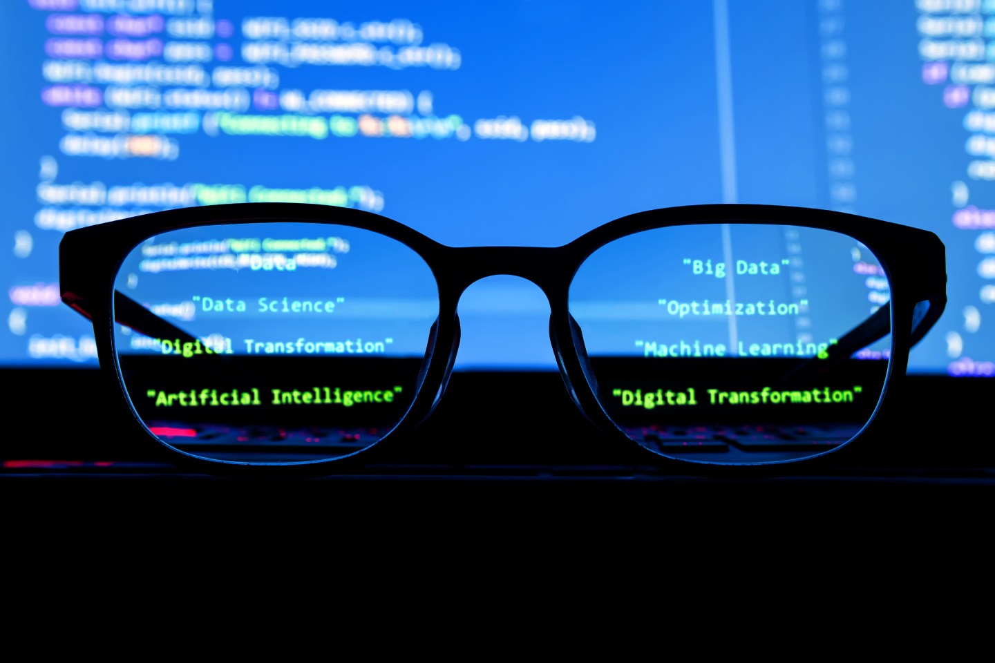 Data scientist , big data , artificial intelligence , machine learning technology concept. Silhouette glasses in front of laptop computer screen with programming coded.