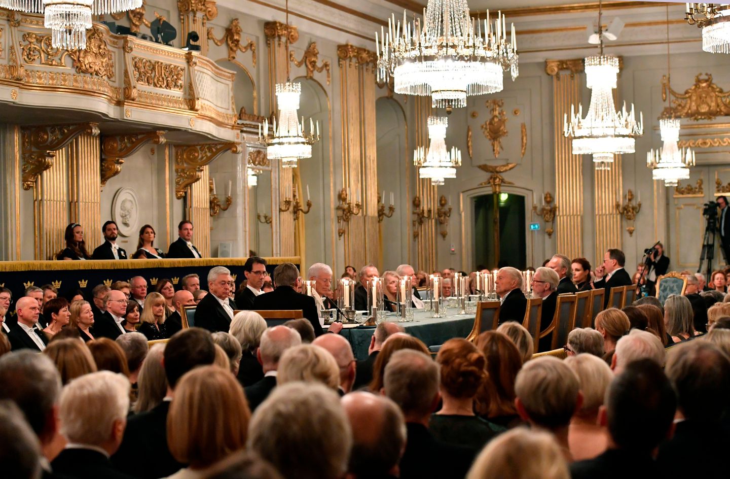 Guests attend Swedish Academy's annual meeting in December where they sit at long, lavish table.