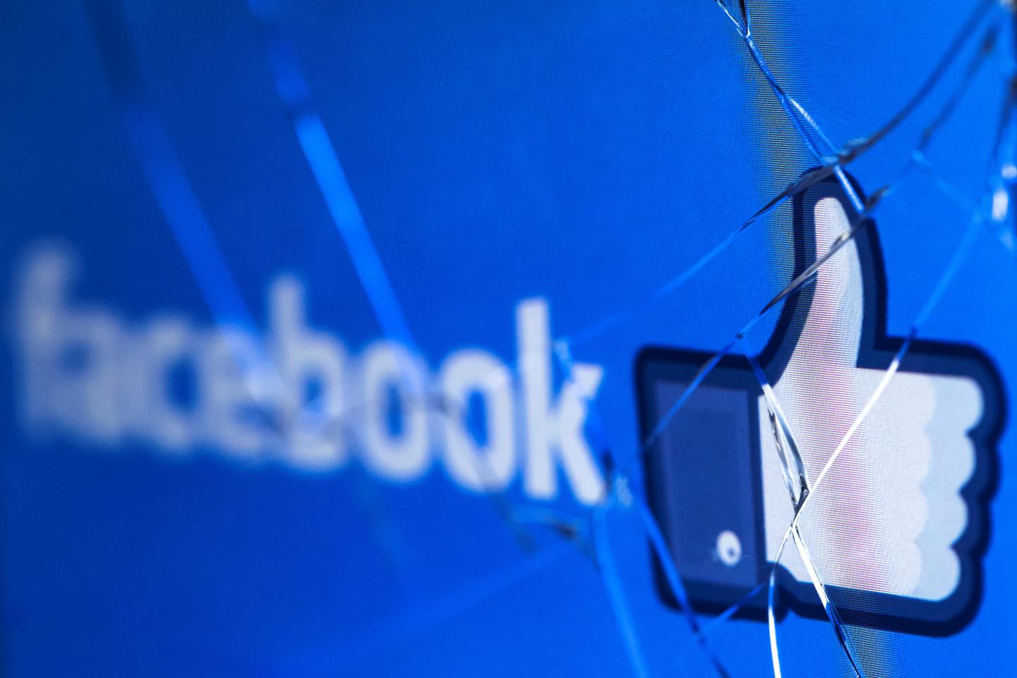 Facebook logo shown behind shattered glass