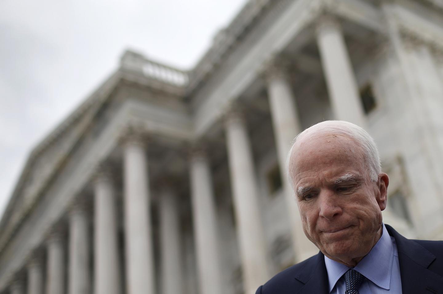 Senator John McCain appears in the bottom right corner in front of the U.S. Capitol building steps. He looks concerned.