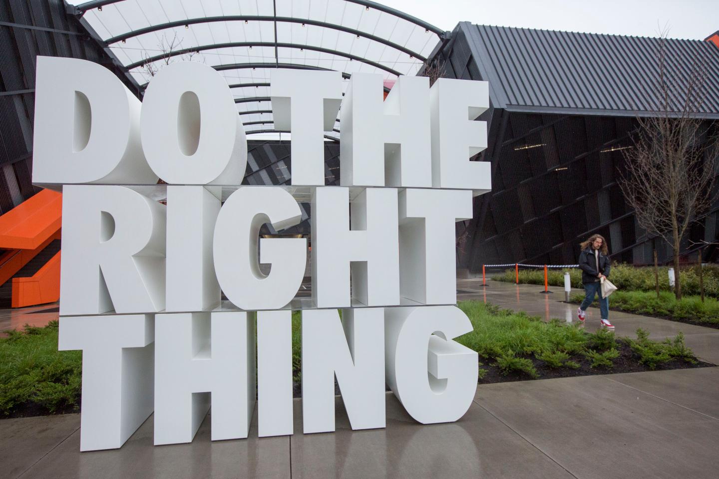 A giant sculpture reads "Do the right thing," in white Nike lettering in front of the company's headquarters