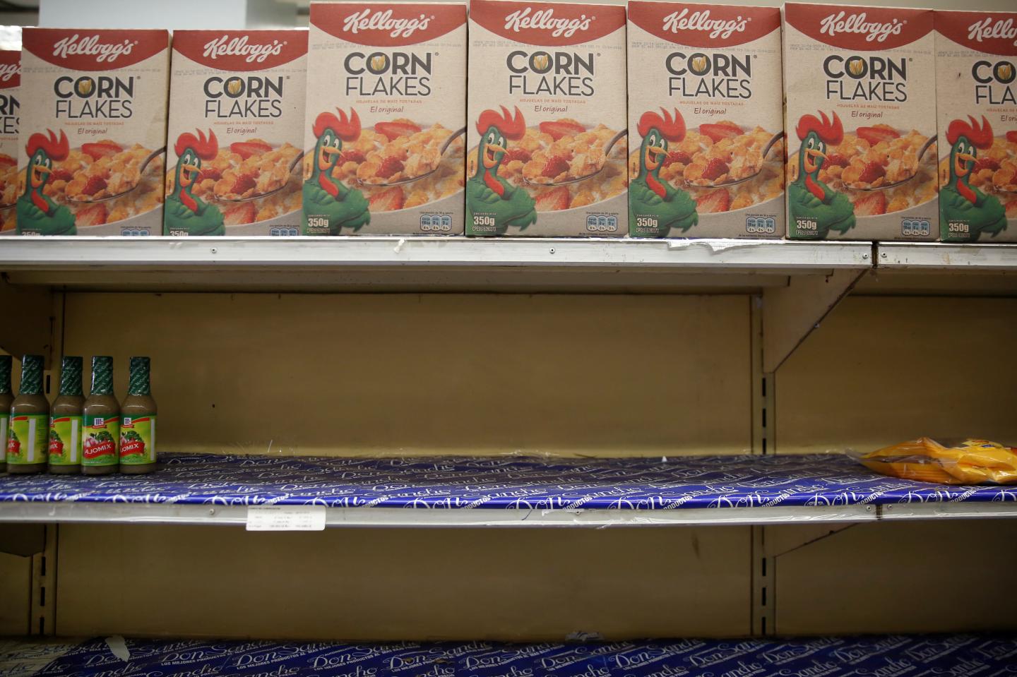 Boxes of corn flakes made by Kellogg are seen on a shelf inside al local shop in Caracas