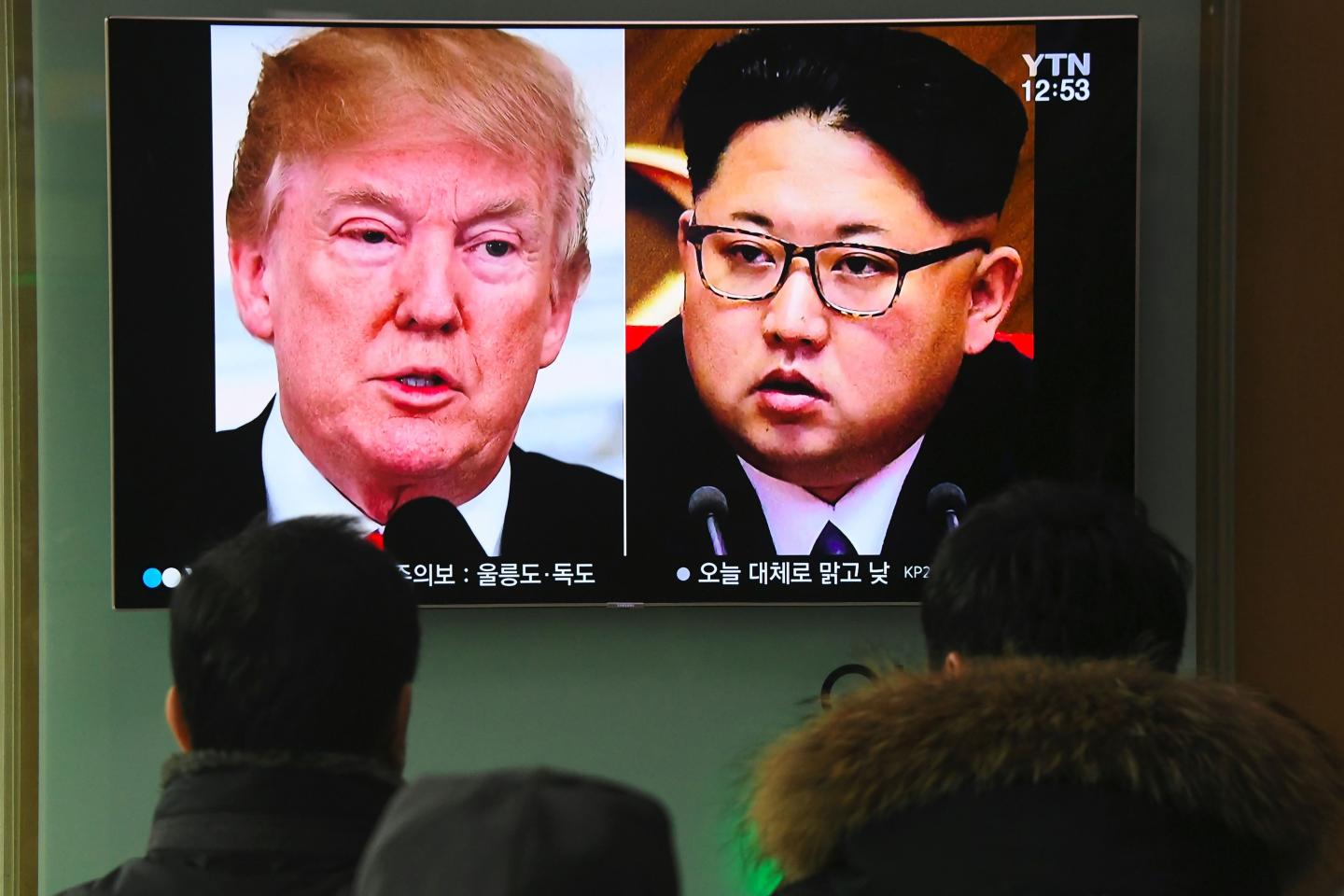 A TV news report showing pictures of U.S. President Donald Trump and North Korean leader Kim Jong Un at a railway station in Seoul.